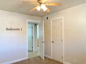 Unfurnished bedroom with ceiling fan, a closet, and light colored carpet