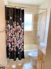 Full bathroom with vanity, tile flooring, shower / tub combo, and toilet