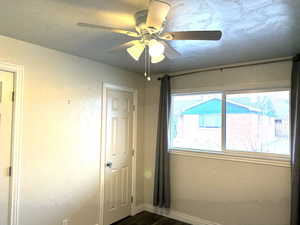 Unfurnished bedroom 1 featuring dark hardwood / wood-style floors and ceiling fan