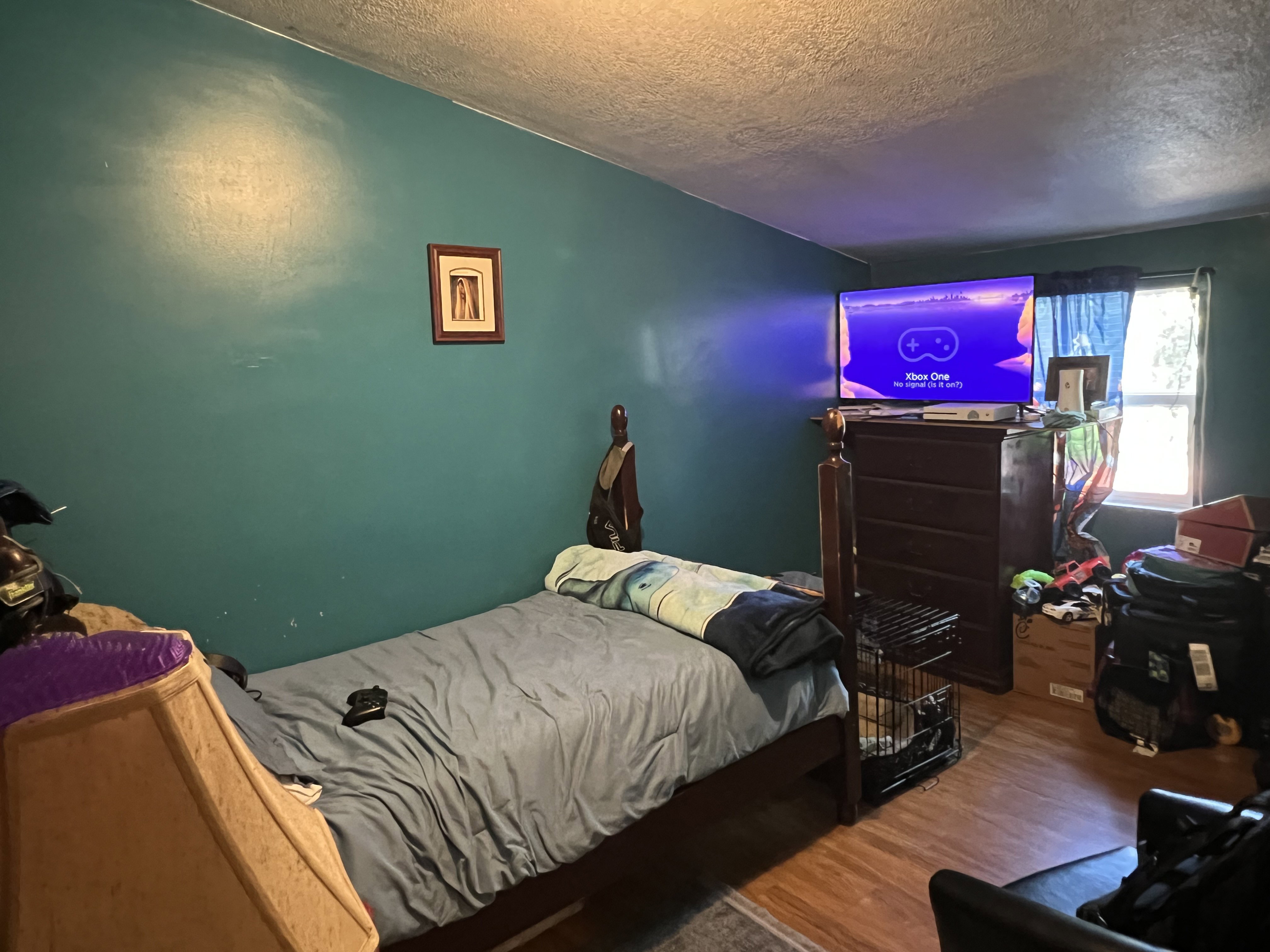 Bedroom with wood-type flooring and a textured ceiling