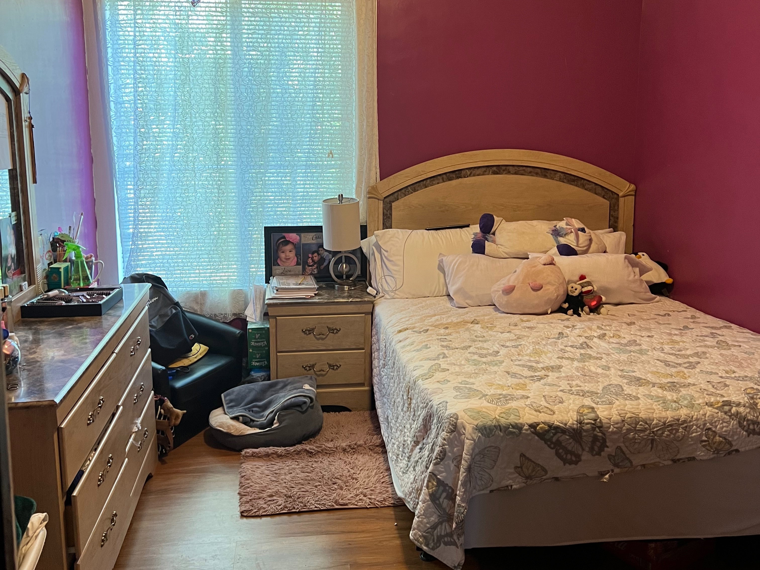 Bedroom with light wood-type flooring and a textured ceiling