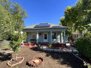 Bungalow-style home with a porch and solar panels