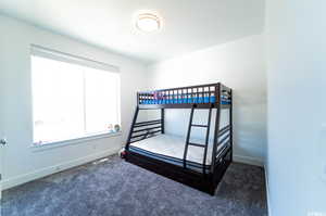 Bedroom featuring dark colored carpet