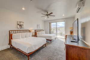 Bedroom featuring a wall mounted AC, ceiling fan, light carpet, and access to exterior