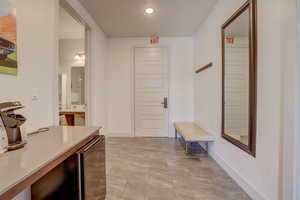 Hallway featuring light tile floors