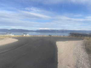 View of road featuring a water and mountain view