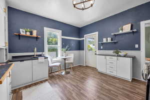 Kitchen featuring sink, and wood-style floors.