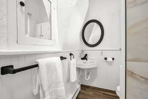 Bathroom with sink, toilet, and hardwood / wood-style flooring