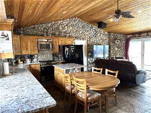 Kitchen with wood ceiling, a center island, stove, backsplash, and ceiling fan