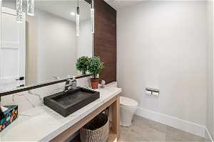 Level 1 Bathroom: Upper level 1/2 bath, tile floor, quartz counter top.