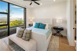 Basement 1 Bedroom: Bedroom 2 of 3. Large open window for views, ceiling fan, attached bathroom.