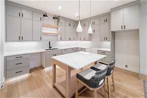 Basement 1 Kitchen: Kitchen 2 with quartz countertops, pendant lighting, Floating shelves, and ample cabinet space.