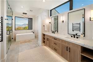 Level 1 Bathroom: Primary bathroom features double vanity, transit 7 underneath lighting, towel warmer, tile flooring