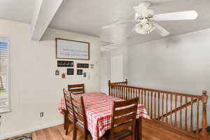 Dining room featuring ceiling fan and light hardwood / wood-style flooring