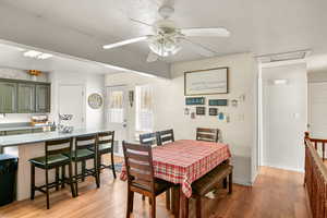 Dining room with ceiling fan and light hardwood / wood-style flooring