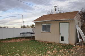 Exterior space featuring a yard and a trampoline