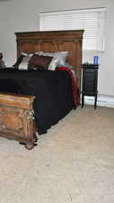 Bedroom featuring light colored carpet