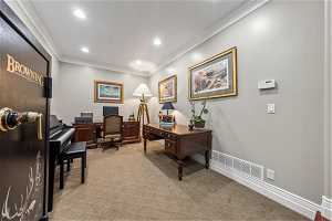 Home office with light carpet and crown molding