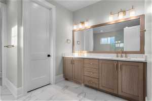 Bathroom featuring tile flooring, dual sinks, and oversized vanity