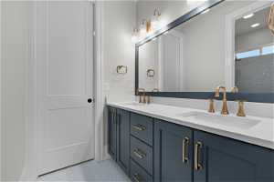 Bathroom with large vanity, double sink, and tile flooring