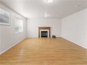 Large living room with light hardwood / wood-style flooring