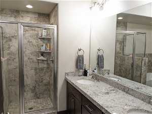 Bathroom with double sink vanity and an enclosed shower