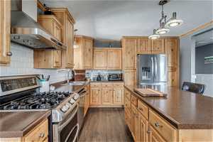 Chef's kitchen with industrial sized hood, range and garbage disposal. Refrigerator stays.