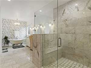 Bathroom with shower with separate bathtub and tile flooring