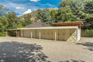 Garage featuring a mountain view and horse stables