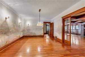 Dining room with Hand-painted murals of local mountains, hardwood floors, crown molding and decorative lighting