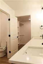 Bathroom with vanity, toilet, and hardwood / wood-style floors