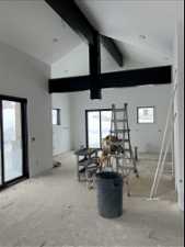 Miscellaneous room with high vaulted ceiling, a healthy amount of sunlight, and beam ceiling
