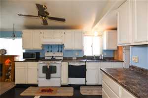 Kitchen featuring dishwasher, sink, ceiling fan, white cabinets, and white electric stove
