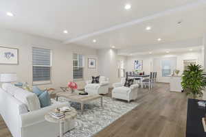 Living room featuring light hardwood / wood-style flooring and beamed ceiling