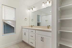 Bathroom featuring double vanity and hardwood / wood-style floors