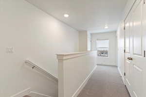 Corridor with light colored carpet