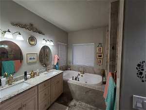 EXAMPLE ONLY - Bathroom featuring dual sinks, independent shower and bath, and vanity with extensive cabinet space