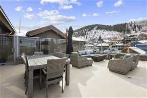 Snow covered patio featuring an outdoor living space and a mountain view