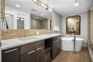Bathroom featuring tile flooring, tasteful backsplash, separate shower and tub, and double vanity