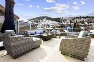Snow covered patio featuring an outdoor hangout area and a mountain view