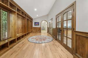 Mudroom featuring vaulted ceiling, light hardwood / wood-style flooring, and french doors