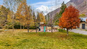 View of yard with a playground and a mountain view