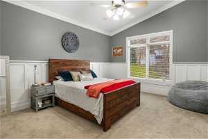 Carpeted bedroom featuring lofted ceiling, ceiling fan, and crown molding