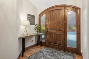 Foyer featuring light hardwood / wood-style flooring and lofted ceiling