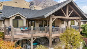 Rear view of house featuring a patio and a deck with mountain view