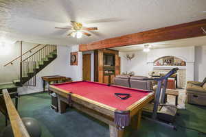 Rec room featuring billiards, ceiling fan, and a textured ceiling