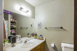 Bathroom with oversized vanity and toilet