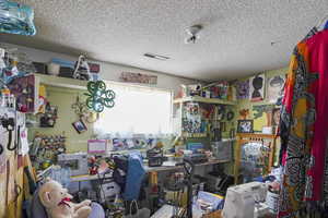 Miscellaneous room with a textured ceiling