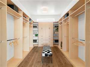 Spacious closet with hardwood / wood-style floors