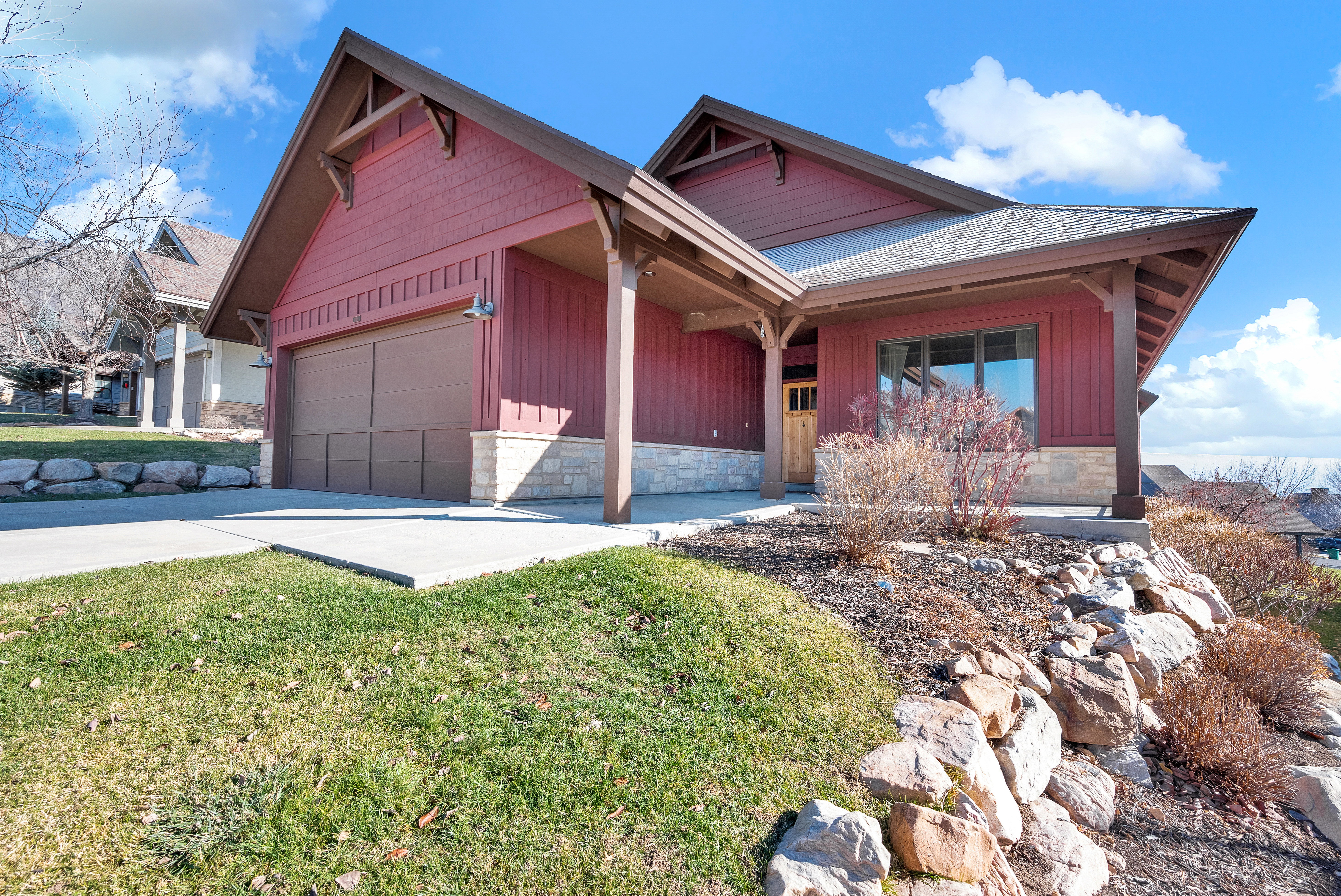 View of front of house featuring a front lawn and a garage